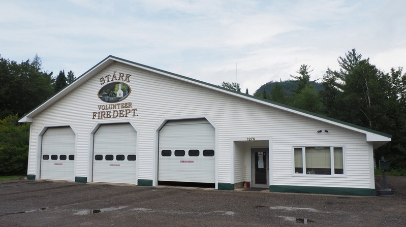 Stark Volunteer Fire Department station - three bay doors with department logo featuring the iconic covered bridge, located at 1276 Stark Highway